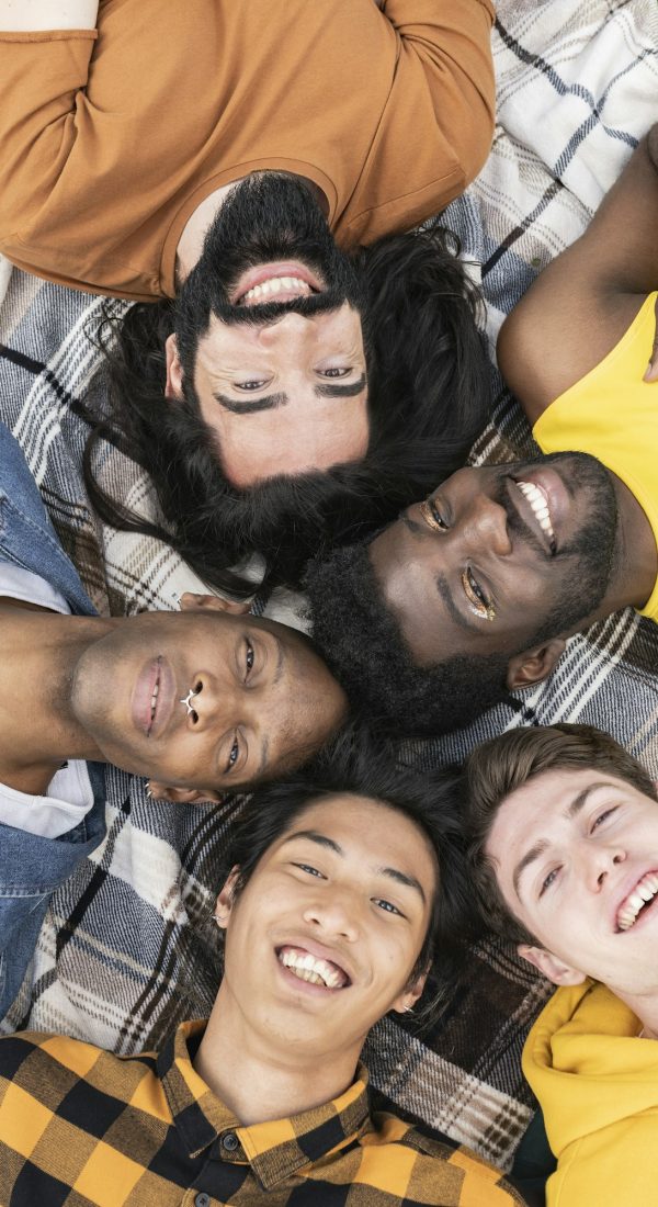 group of men friends lying on the grass diversity of people of different orientations